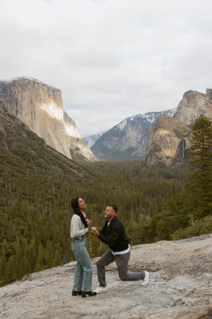 Man proposing on one knee to woman at Tunnel View Yosemite