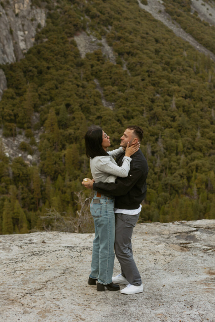 Man proposing on one knee to woman at Tunnel View YosemiteSurprise proposal at Tunnel View Yosemite