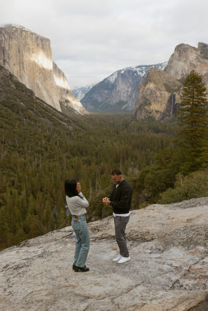 Man proposing on one knee to woman at Tunnel View Yosemite