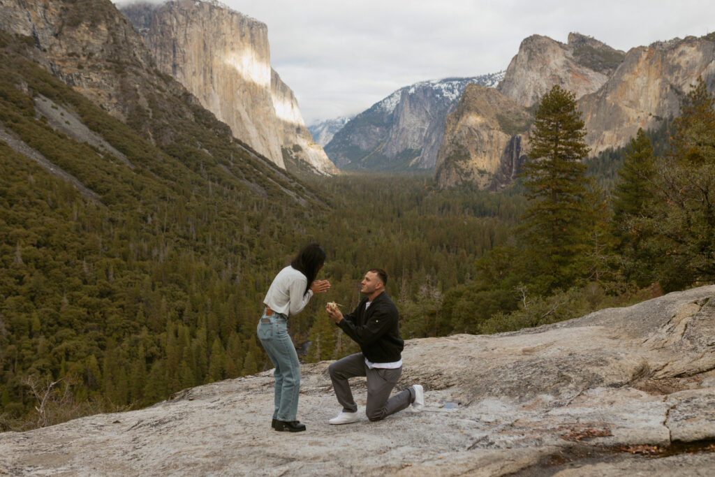 Man proposing on one knee to woman at Tunnel View Yosemite