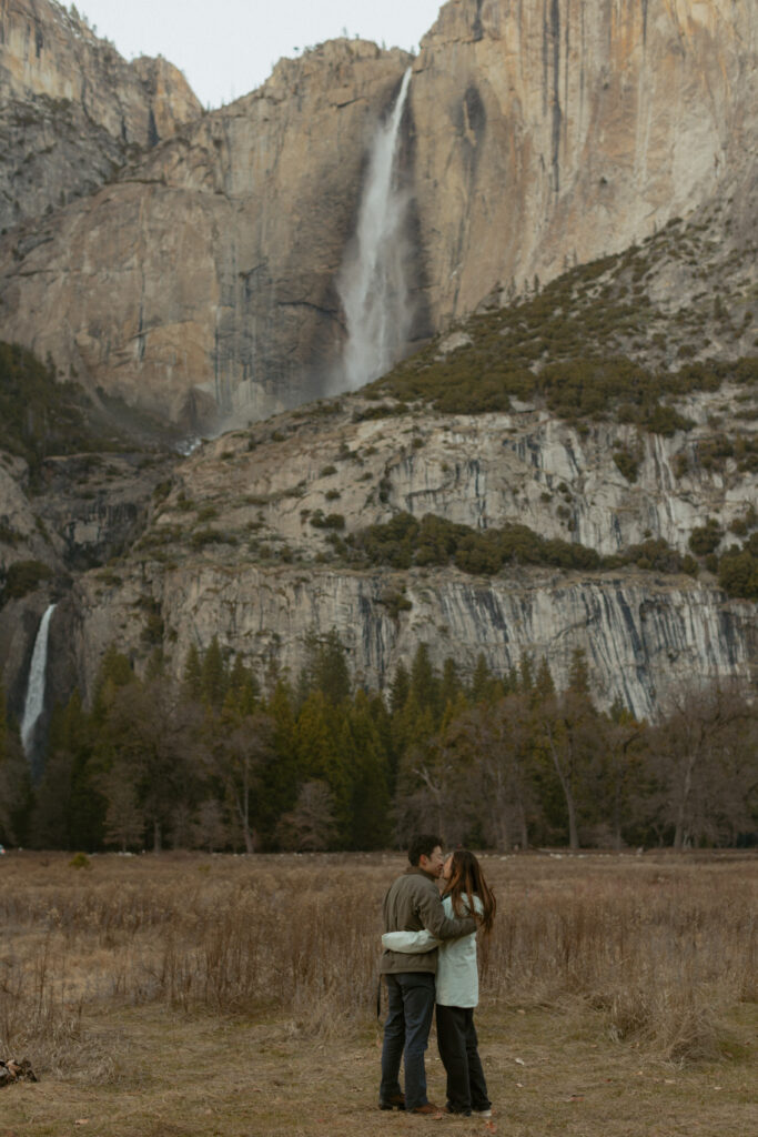 Intimate Yosemite engagement photos in Cooks Meadow after surprise proposal with winter light in Yosemite Valley.