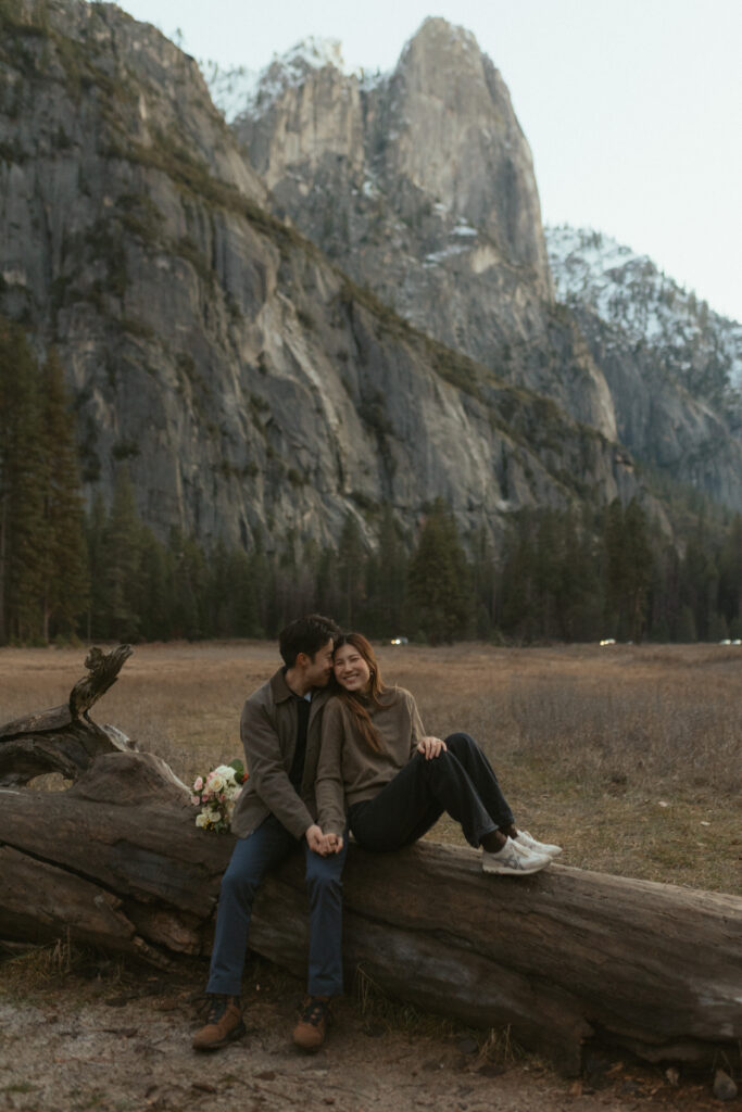 Emotional surprise proposal in Cooks Meadow Yosemite as Johnny kneels and Lydia reacts with laughter and tears.