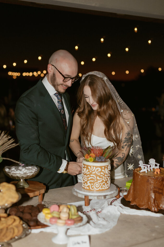Intimate wedding photos taken by an Arizona Wedding photographer in the Desert, couples cuts the cake at there desert Wedding Reception,