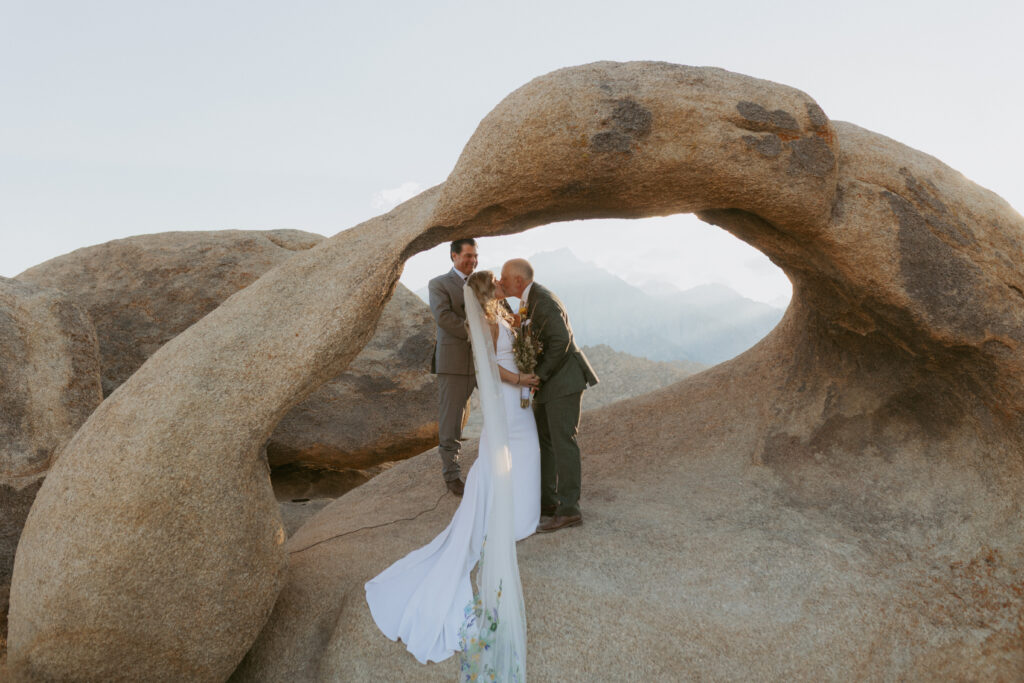 Couple says I do at Mobius Arch in Alabama Hills Lone Pine/ Hire a California Elopement Photographer to Capture your desert Wedding day 