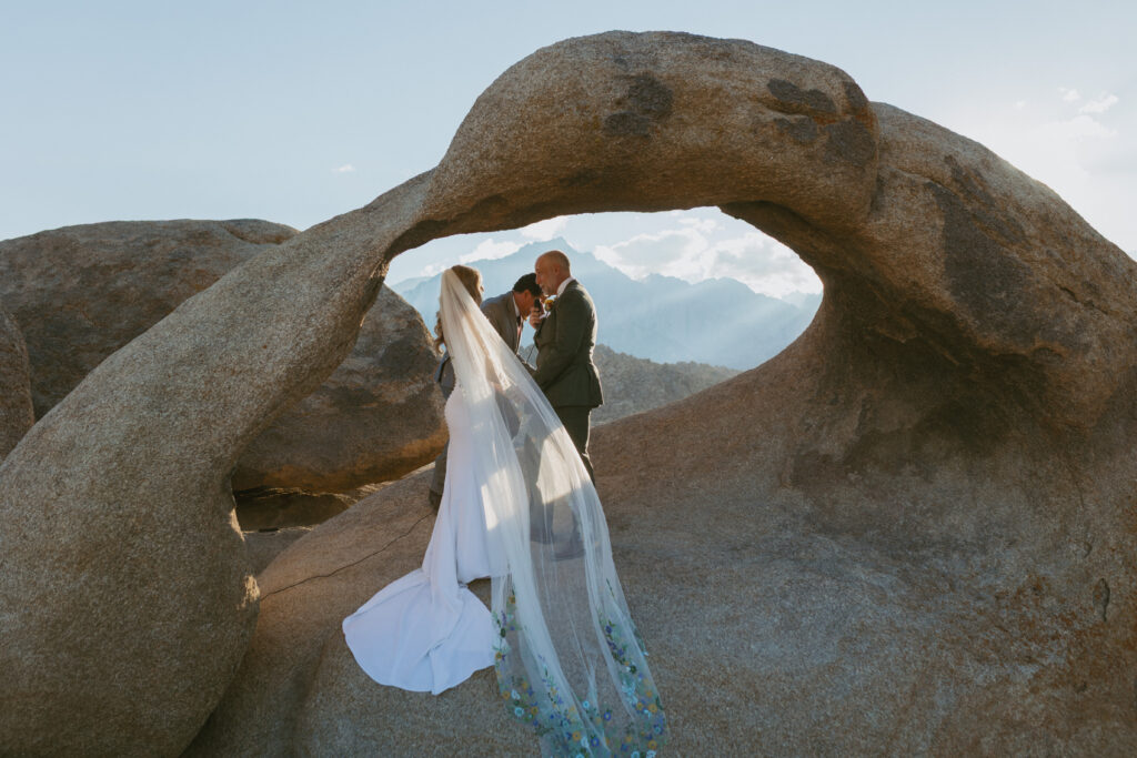Couple says I do at Mobius Arch in Alabama Hills Lone Pine/ Hire a California Elopement Photographer to Capture your desert Wedding day 