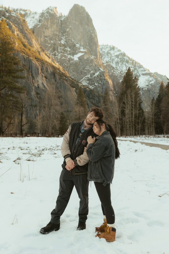 Couples engagement session in snowy cooks meadow in Yosemite National Park 
