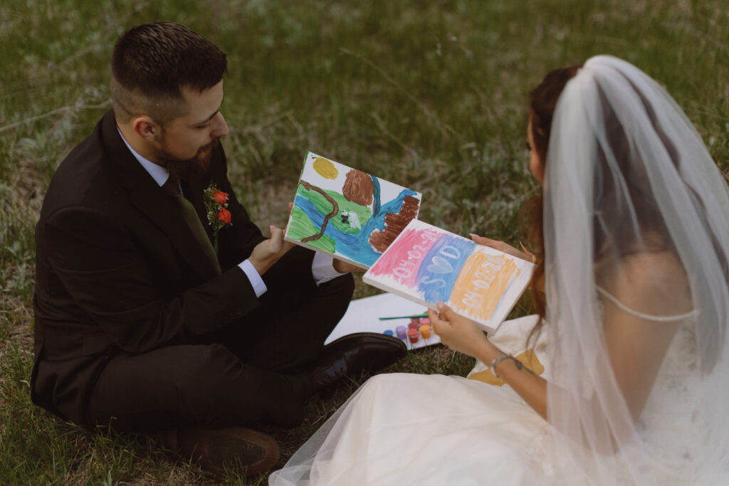 Elopement Ideas, A couple painting in cooks meadow on their elopement day In Yosemite National Park 