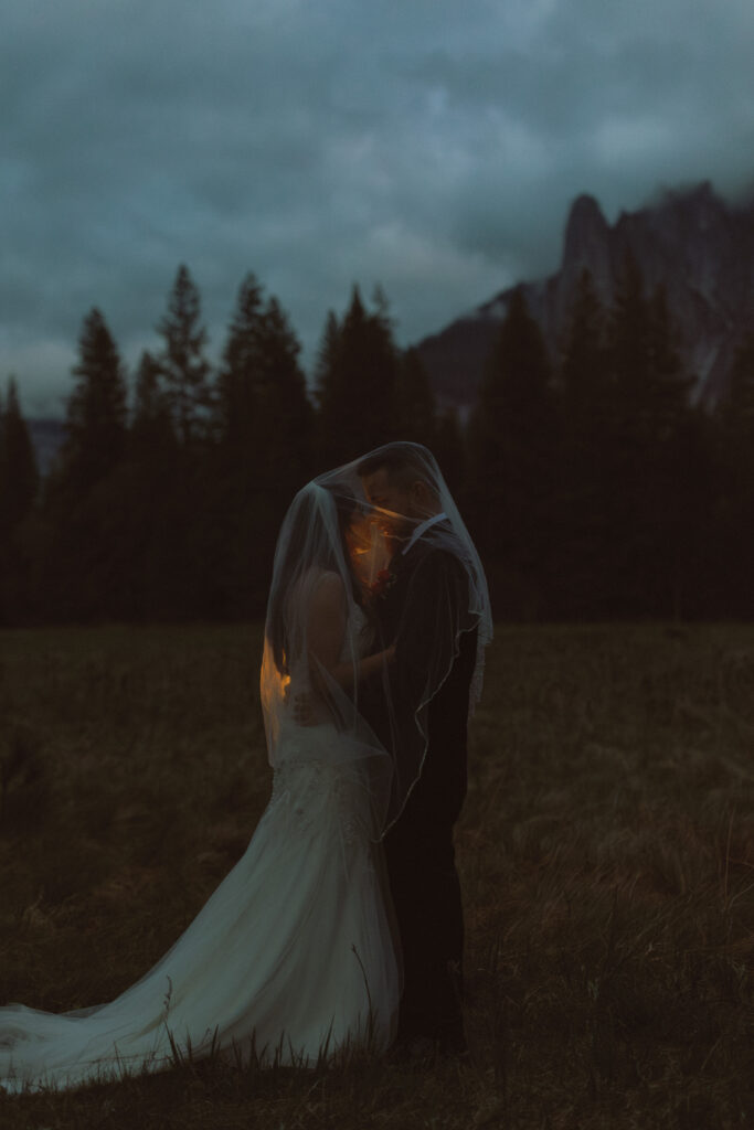 Couple Embraces in a moody Elopement in Yosemite National Park in El Cap meadow, Elopement in Yosemite National Park 