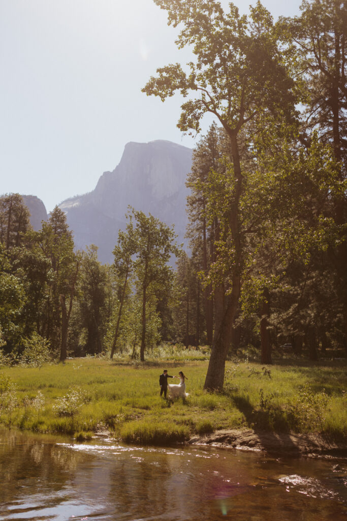sunrise wedding portraits of bride and groom in Yosemite meadows 
