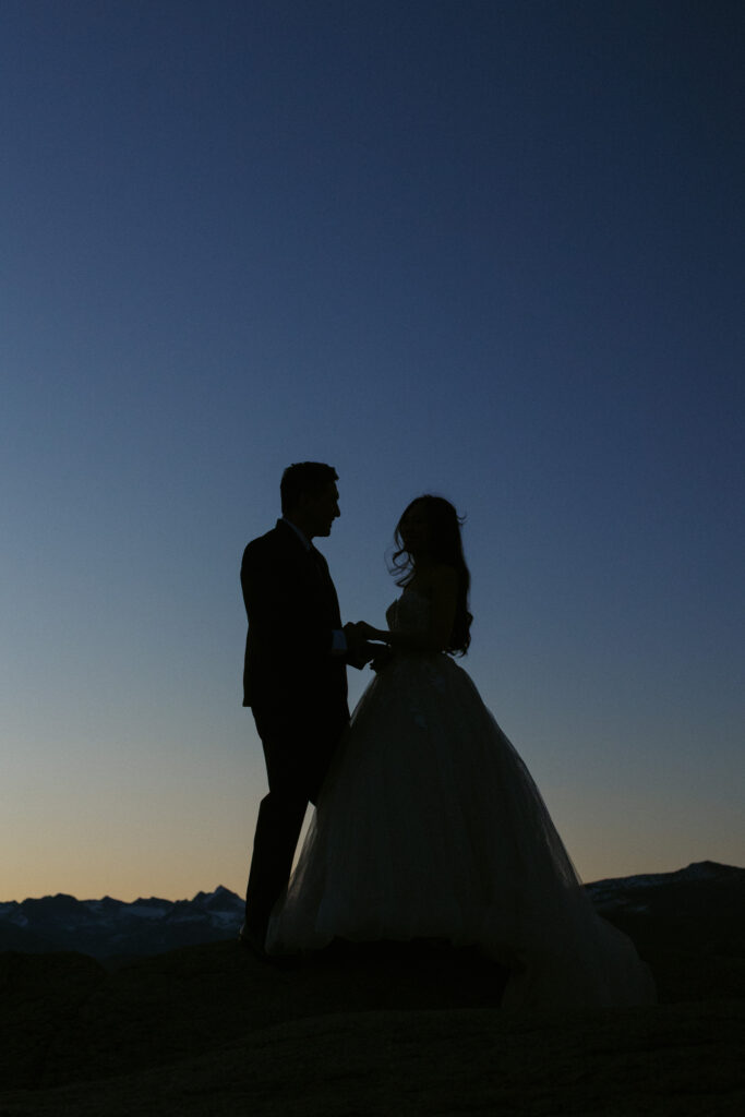 Early sunrise blue hour in Yosemite couple is silhouetted 