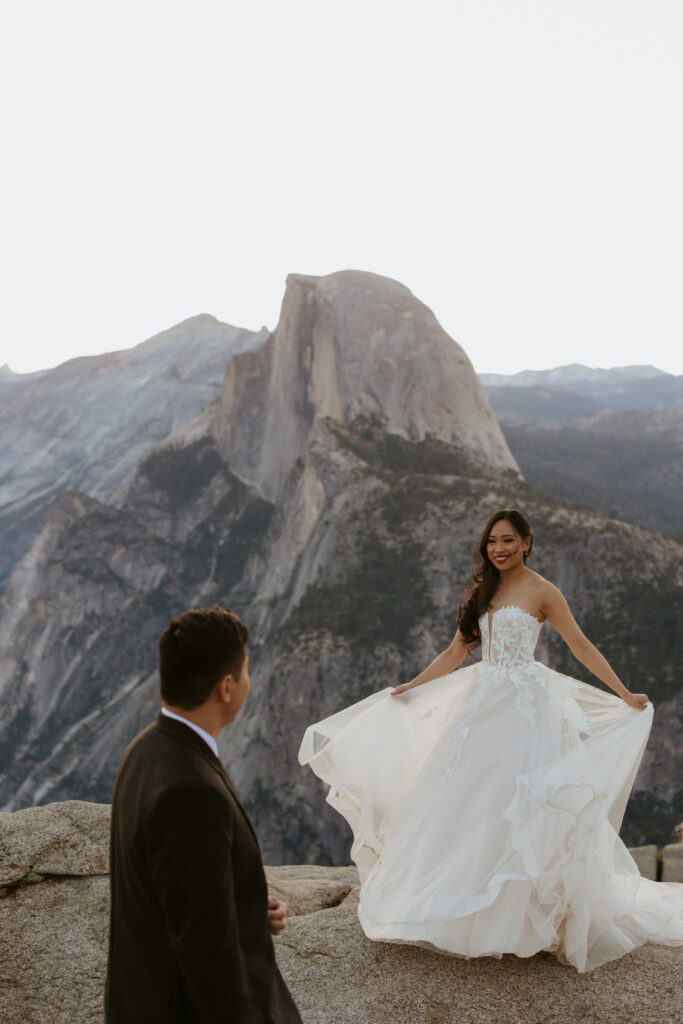early morning sunrise couples dance together with half dome in the background on top of glacier point 