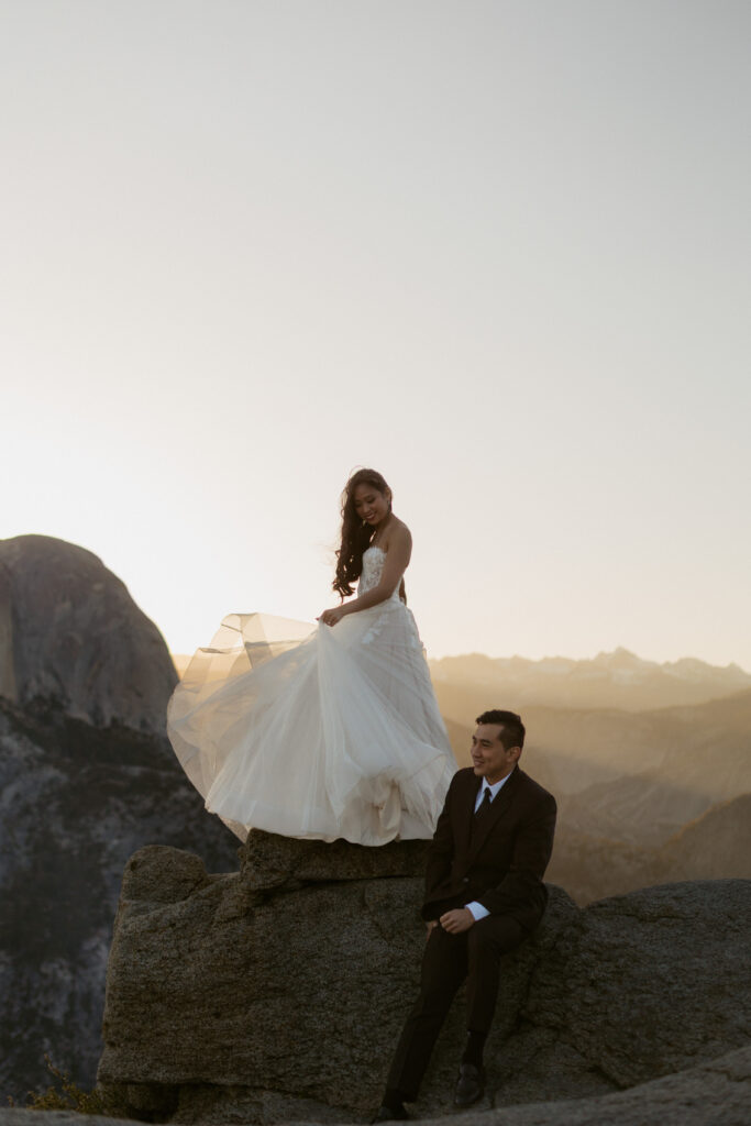 Yosemite wedding portraits at glacier point with half dome in the back in the early morning sunlight 