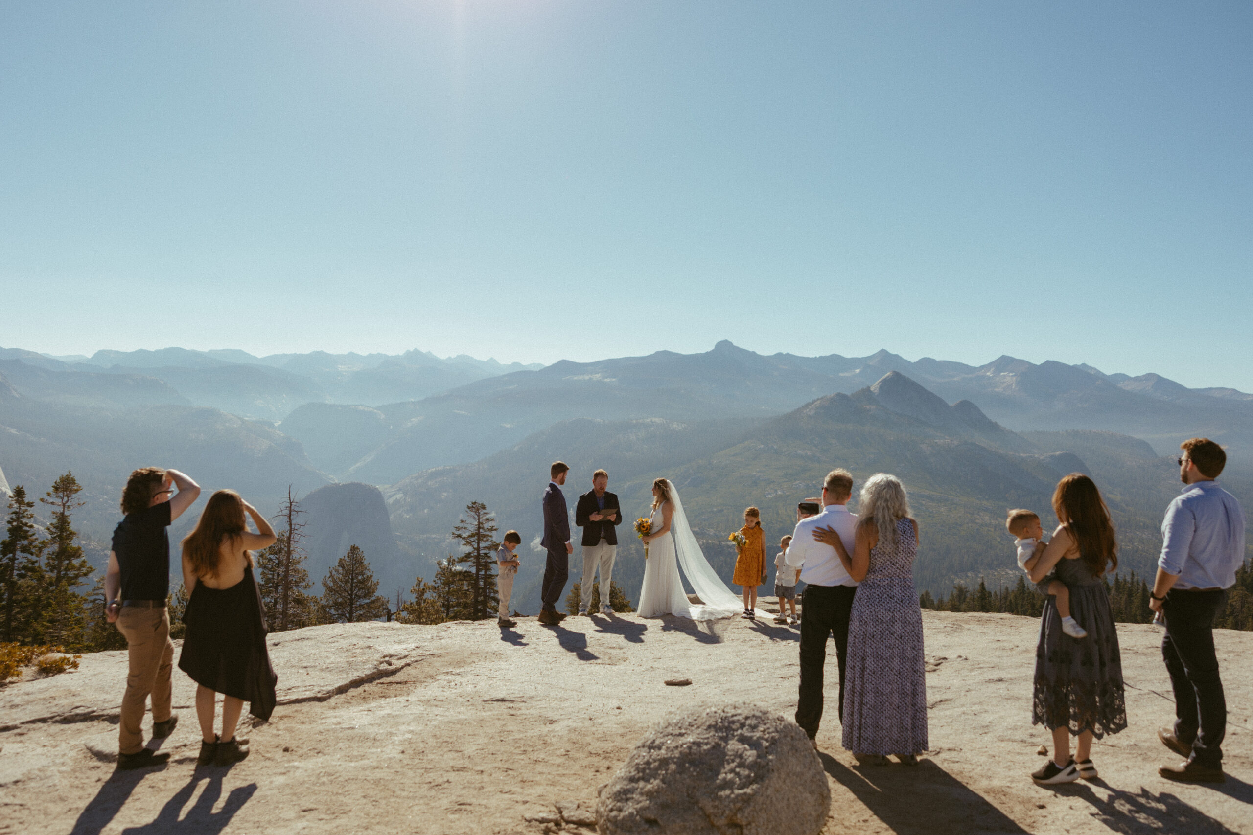 A California Elopement Photographer takes couples ceremony photos on top of a mountian.
